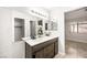 Double vanity bathroom with modern finishes and a view of the bedroom at 7921 Cadenza Ln, Las Vegas, NV 89123