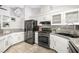 Modern kitchen features granite countertops, stainless steel appliances, and white cabinets at 7921 Cadenza Ln, Las Vegas, NV 89123