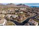 Neighborhood aerial view featuring homes, mountain views, and a winding road at 12002 Tramonto Ave, Las Vegas, NV 89138