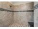 Spacious shower featuring neutral tile work with decorative border and built in bench seating at 12002 Tramonto Ave, Las Vegas, NV 89138