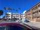 Exterior of the building features tall palm trees and ample parking at 1381 E University Ave # 102, Las Vegas, NV 89119