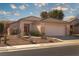 Single-story house with a red door and well-maintained landscaping at 2179 Point Mallard Dr, Henderson, NV 89012