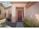 Inviting red front door entrance with landscaping at 2179 Point Mallard Dr, Henderson, NV 89012