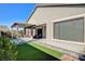 Inviting backyard featuring a refreshing pool, covered patio, and green turf area for relaxation and entertaining at 2391 Dalewood Ave, North Las Vegas, NV 89086