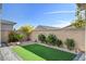 Backyard features artificial grass, lush landscaping, and a private outdoor space at 2391 Dalewood Ave, North Las Vegas, NV 89086