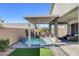 Private backyard oasis with a cozy plunge pool, covered patio, and lush landscaping perfect for outdoor enjoyment at 2391 Dalewood Ave, North Las Vegas, NV 89086