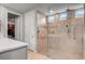 This bathroom has a glass-walled shower with tile accents, a shower bench, and a double shower head at 2391 Dalewood Ave, North Las Vegas, NV 89086