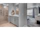The bathroom has tile floors, gray cabinets, and access to the bedroom at 2391 Dalewood Ave, North Las Vegas, NV 89086