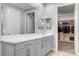 A view of the bathroom with its double vanity sink, and access to the walk-in closet at 2391 Dalewood Ave, North Las Vegas, NV 89086