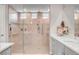 This bathroom features a glass shower with wall tile accents, a bench, and double shower heads at 2391 Dalewood Ave, North Las Vegas, NV 89086