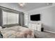 Spacious bedroom with a modern design, plush carpet, a large TV and access to a patio at 2391 Dalewood Ave, North Las Vegas, NV 89086