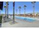 Resort-style community pool with palm trees and lounge chairs, perfect for relaxing and enjoying the outdoors at 2391 Dalewood Ave, North Las Vegas, NV 89086