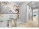 Bright foyer featuring light wood floors, modern art, and a stylish glass console table at 2391 Dalewood Ave, North Las Vegas, NV 89086