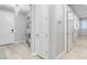 Hallway with light wood floors, leading to the front door, bedrooms and living spaces at 2391 Dalewood Ave, North Las Vegas, NV 89086