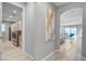 Bright hallway with light grey walls and wood-look flooring at 2391 Dalewood Ave, North Las Vegas, NV 89086