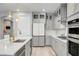 Bright kitchen with stainless steel appliances, gray cabinets, and quartz countertops at 2391 Dalewood Ave, North Las Vegas, NV 89086