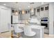 Well-equipped kitchen featuring an island with seating, stainless appliances, and bright, open design at 2391 Dalewood Ave, North Las Vegas, NV 89086
