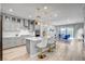 Spacious kitchen with seating at the island, stainless steel appliances, and gray cabinets at 2391 Dalewood Ave, North Las Vegas, NV 89086