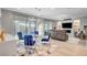 Open living room featuring a modern chandelier, fireplace, and sliding glass doors to the backyard at 2391 Dalewood Ave, North Las Vegas, NV 89086