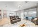 Bright living room with backyard views, modern furnishings, and an open concept layout at 2391 Dalewood Ave, North Las Vegas, NV 89086