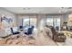 Open-concept living space with modern furnishings, dining area, and bright natural light at 2391 Dalewood Ave, North Las Vegas, NV 89086