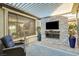 Covered patio featuring a fireplace and tv, great for outdoor relaxation at 2391 Dalewood Ave, North Las Vegas, NV 89086