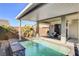 Beautiful covered pool area with ladders and a tranquil waterfall feature at 2391 Dalewood Ave, North Las Vegas, NV 89086