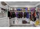 Spacious walk-in closet with shelving, cabinets, and carpet floors to neatly organize clothes and shoes at 2391 Dalewood Ave, North Las Vegas, NV 89086