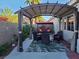 Relaxing backyard patio with shaded pergola, swing, and outdoor seating area at 5048 Orchid Springs St, Las Vegas, NV 89148