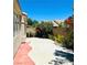 View of the backyard featuring a concrete pad, block wall, and shrubbery at 5048 Orchid Springs St, Las Vegas, NV 89148