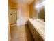 Spacious primary bathroom boasting dual sinks, a soaking tub, and a separate glass-enclosed shower at 5048 Orchid Springs St, Las Vegas, NV 89148