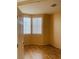 Bedroom featuring gleaming hardwood floors and ample natural light from two large windows at 5048 Orchid Springs St, Las Vegas, NV 89148