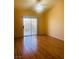 Bright bedroom featuring wood-look flooring and sliding glass doors to the backyard at 5048 Orchid Springs St, Las Vegas, NV 89148