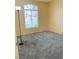 Cozy bedroom with neutral walls, large window letting in natural light and carpet flooring at 5048 Orchid Springs St, Las Vegas, NV 89148