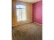 Bright bedroom with carpet, large window, and accent wall at 5048 Orchid Springs St, Las Vegas, NV 89148