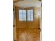 A well-lit bedroom with neutral walls, wood flooring, and large windows at 5048 Orchid Springs St, Las Vegas, NV 89148