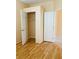 Bedroom showcasing neutral walls, wood flooring, and closet at 5048 Orchid Springs St, Las Vegas, NV 89148