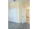 Bedroom featuring gray carpeting, closet with sliding doors and an open doorway at 5048 Orchid Springs St, Las Vegas, NV 89148