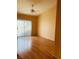 Bright bedroom featuring wood-look flooring and sliding glass doors to the backyard at 5048 Orchid Springs St, Las Vegas, NV 89148