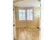 Bedroom featuring hardwood flooring, a window and a standing lamp at 5048 Orchid Springs St, Las Vegas, NV 89148
