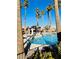 Enjoy the community pool, featuring lounge chairs, a shade cover, and desert landscaping at 5048 Orchid Springs St, Las Vegas, NV 89148