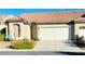 Charming single-story home showcasing a tile roof, arched window, and well-maintained landscaping at 5048 Orchid Springs St, Las Vegas, NV 89148