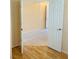 The hallway offers wood flooring, neutral walls and flows to an open room with tile flooring at 5048 Orchid Springs St, Las Vegas, NV 89148