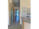 Hallway leading to a foyer with neutral colors and tile floors with kitchen access at 5048 Orchid Springs St, Las Vegas, NV 89148