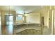 Bright kitchen with granite countertops, white cabinets, and a breakfast bar overlooking the living area at 5048 Orchid Springs St, Las Vegas, NV 89148