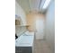 Laundry room equipped with modern washer and dryer, storage shelf, and tile flooring at 5048 Orchid Springs St, Las Vegas, NV 89148