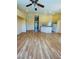 Large open-concept living and dining area with beautiful hardwood floors, vaulted ceilings, and neutral paint tones at 5048 Orchid Springs St, Las Vegas, NV 89148