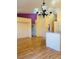 Spacious living room with hardwood floors and modern lighting fixture at 5048 Orchid Springs St, Las Vegas, NV 89148