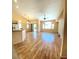 Spacious living room featuring wood flooring, large windows offering plenty of light, and a ceiling fan at 5048 Orchid Springs St, Las Vegas, NV 89148