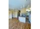 Open floor plan with light colored walls, laminate floors, and access to a kitchen at 5048 Orchid Springs St, Las Vegas, NV 89148